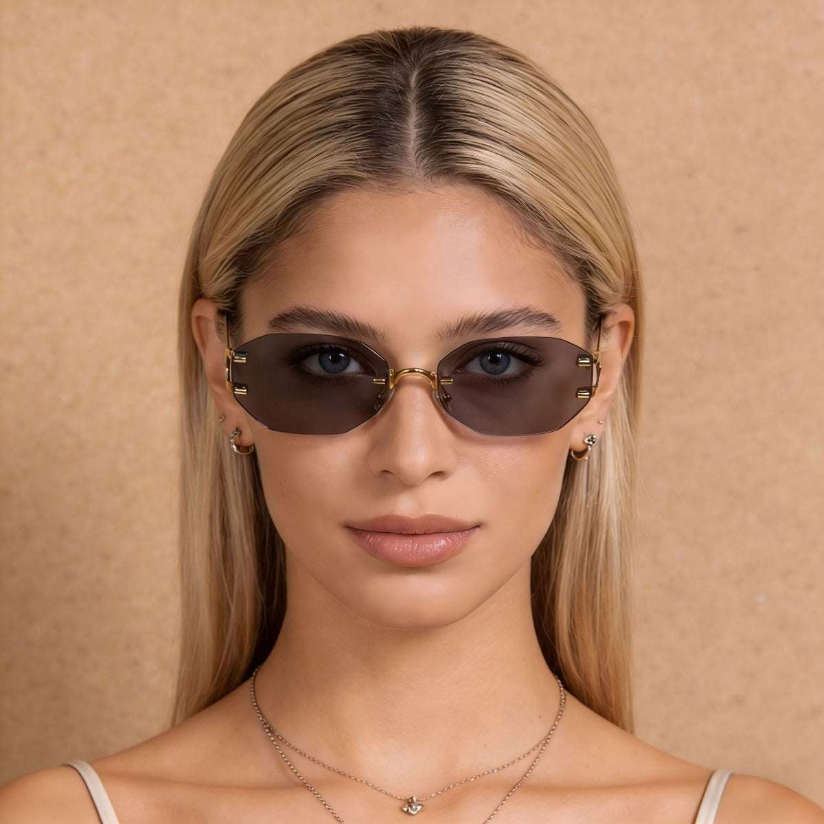 Rimless oval sunglasses with gold metal frame and UV400 protection