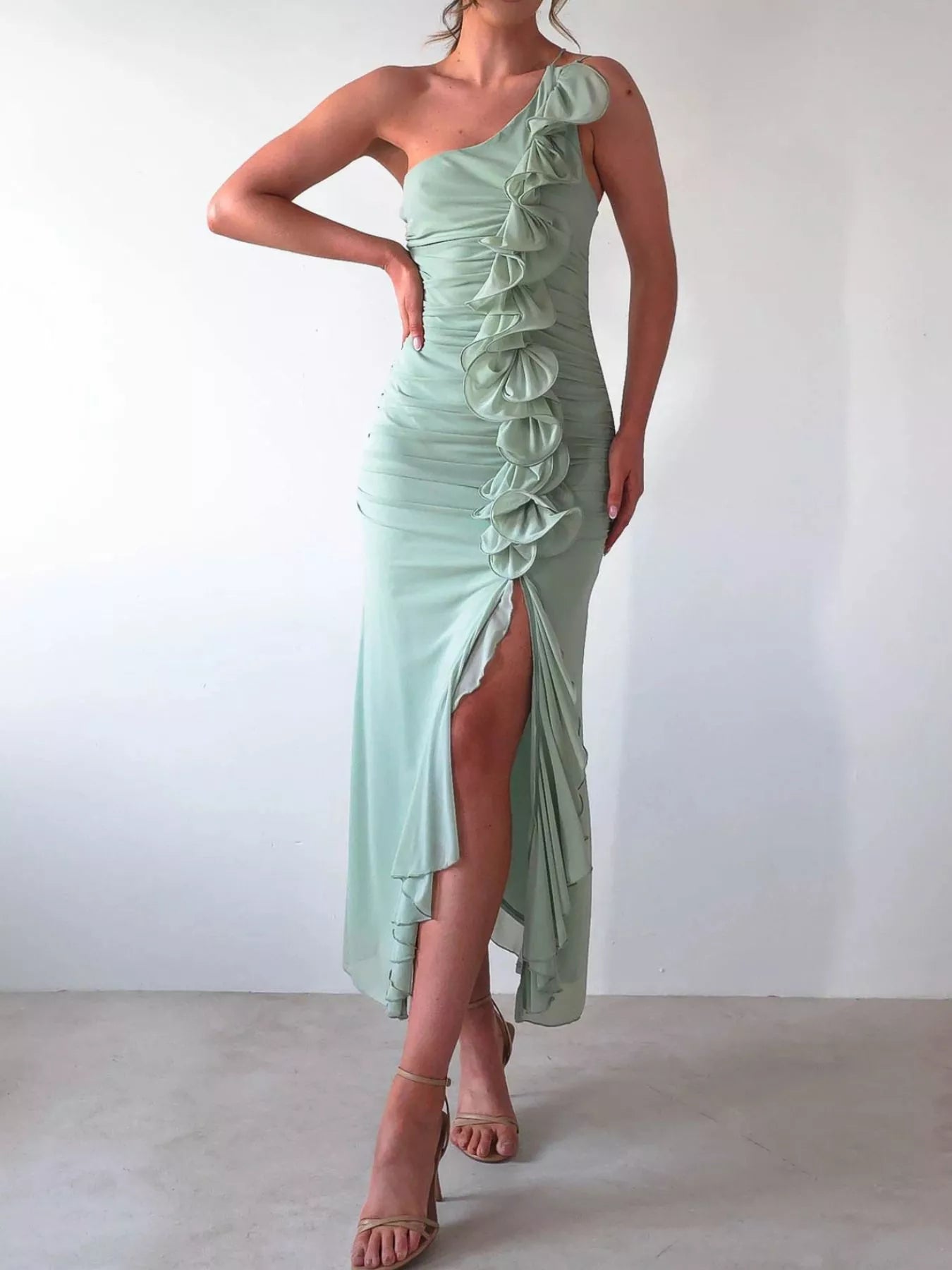 Black one-shoulder ruffle slit dress with zipper and ruched detail