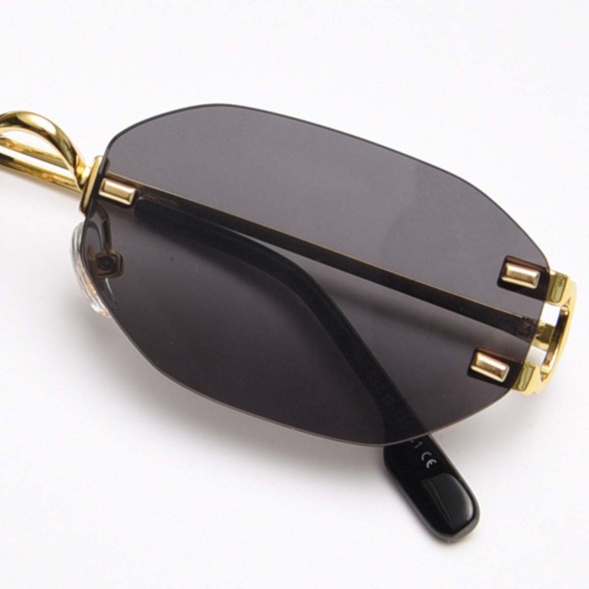Rimless oval sunglasses with gold metal frame and UV400 protection