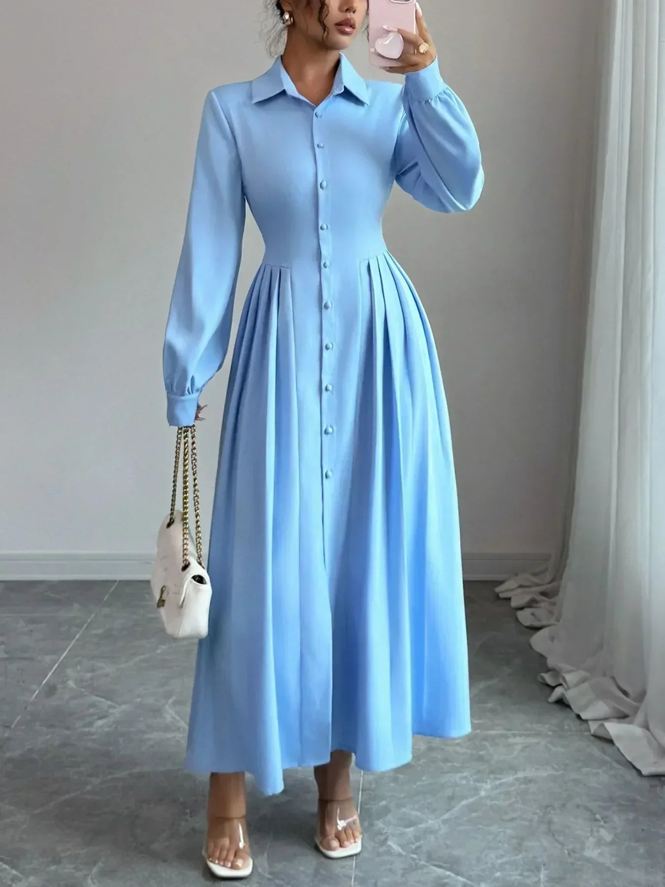 Woman wearing a button-front maxi shirt dress with ruched detailing and long sleeves