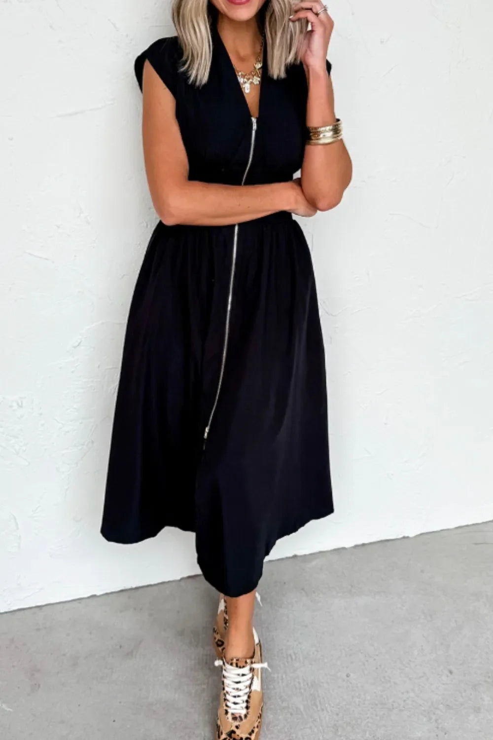 Black sleeveless zip-front maxi dress with pockets and no stretch polyester fabric