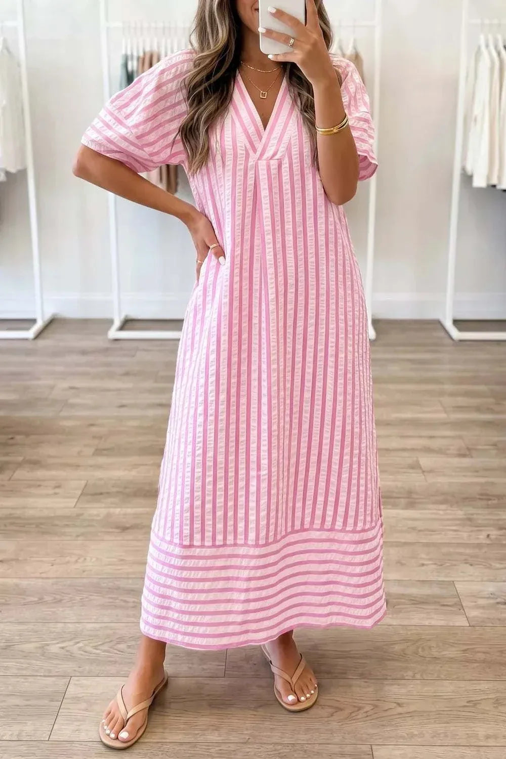 Woman wearing a striped V-neck midi dress with a basic slightly stretchy design