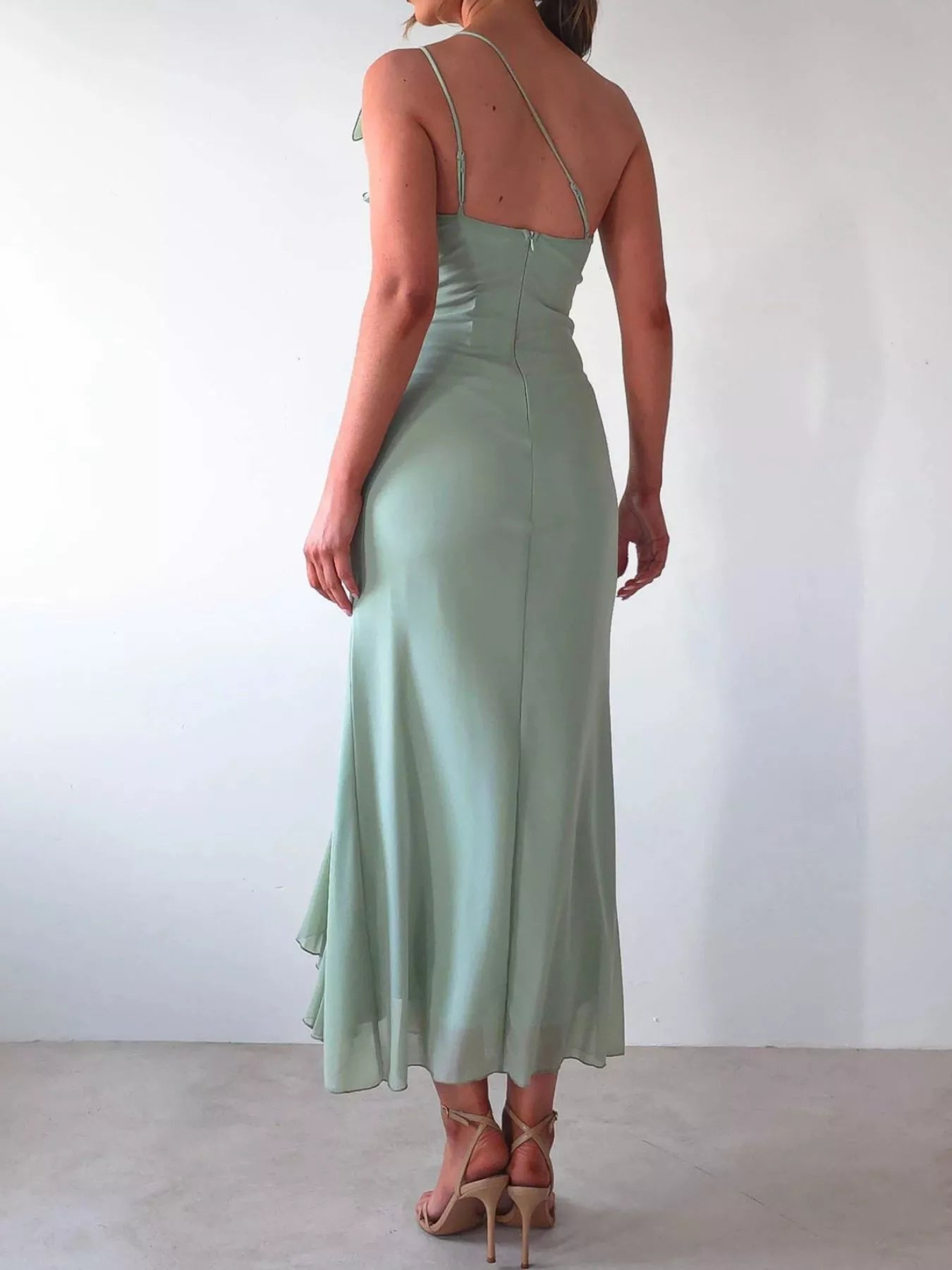Black one-shoulder ruffle slit dress with ruched zipper and slight stretch polyester fabric