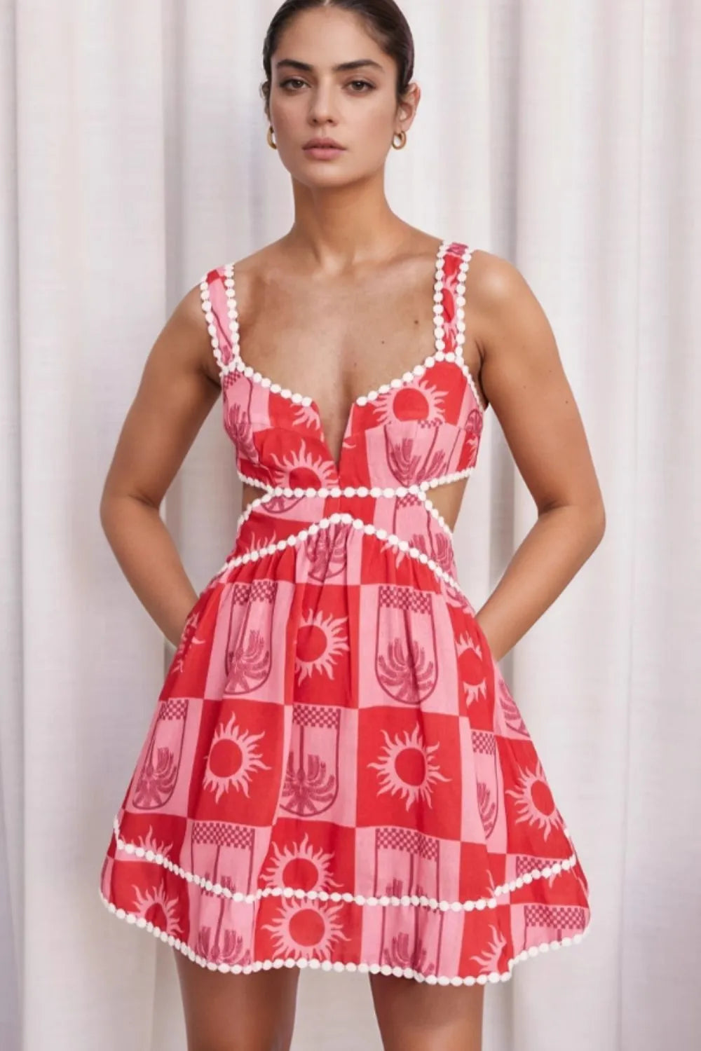 Woman wearing a cutout printed mini dress made of 100% polyester with no stretch and machine washable design
