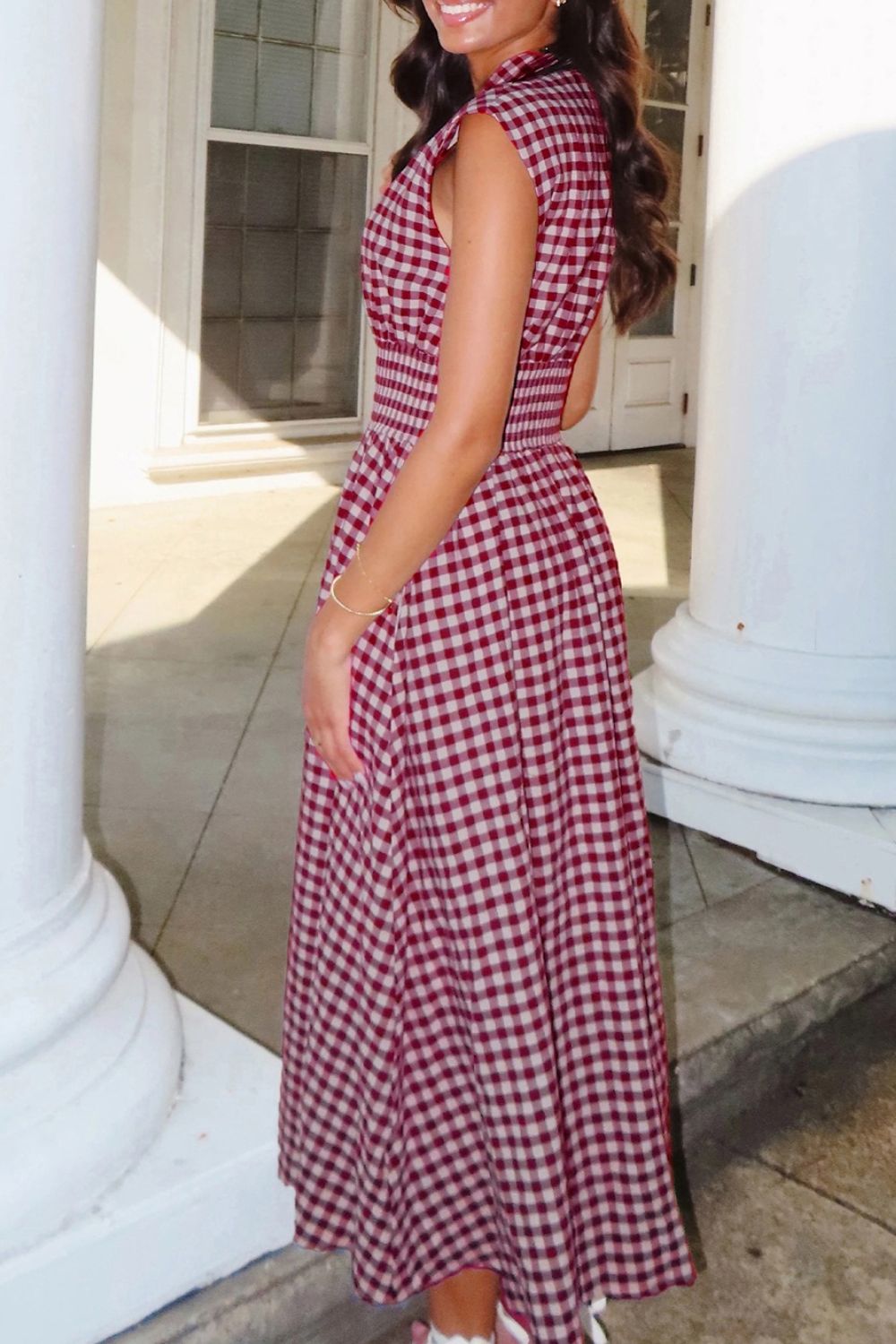Woman wearing a gingham zip-front midi dress with no stretch and zipper detail