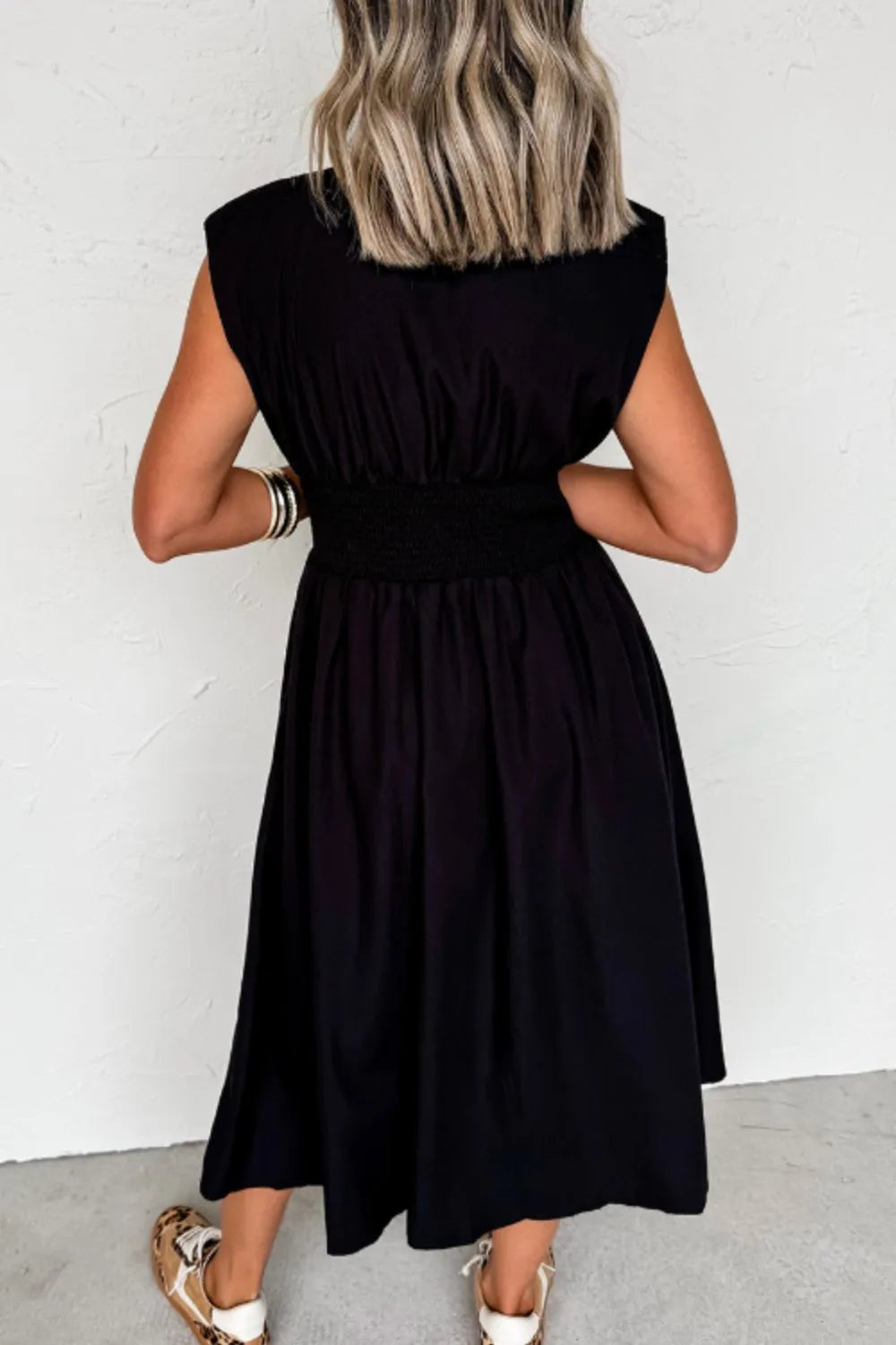 Black sleeveless zip-front maxi dress with pockets and no stretch polyester fabric