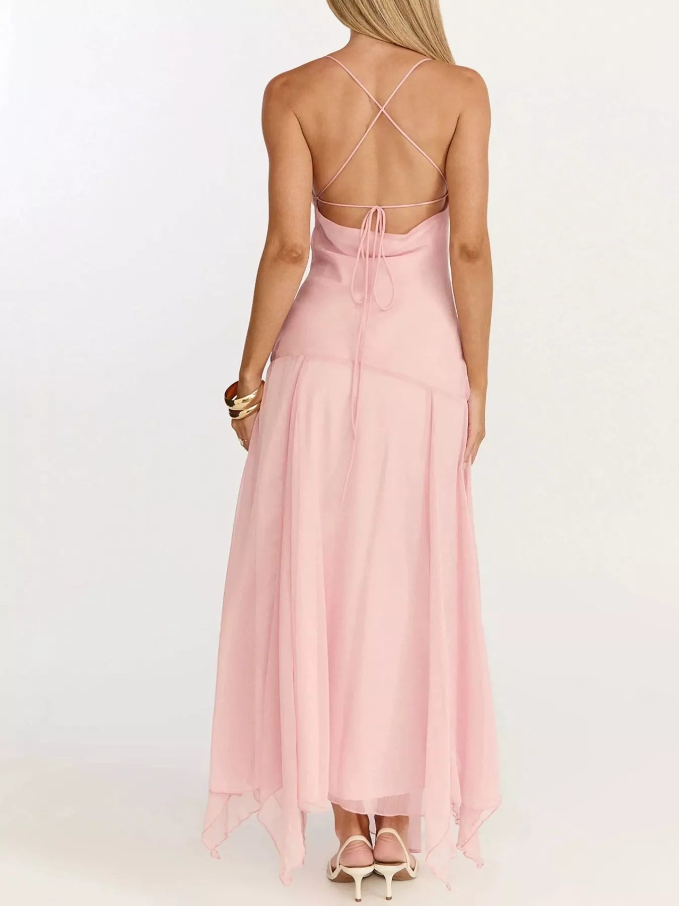 Woman wearing a slit spaghetti strap dress with tied details and slight stretch