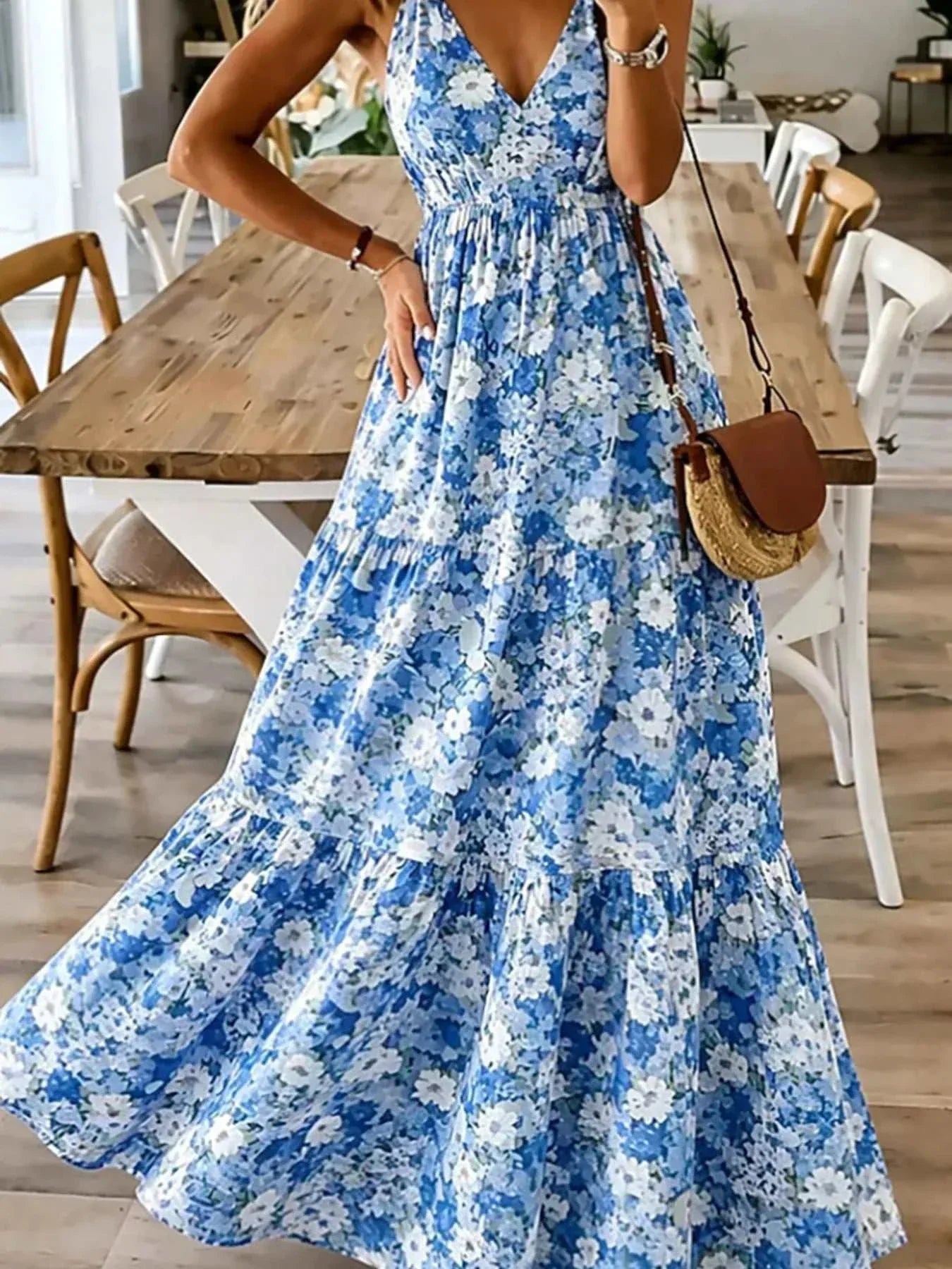 Woman wearing floral print maxi dress with spaghetti straps and tiered ruching