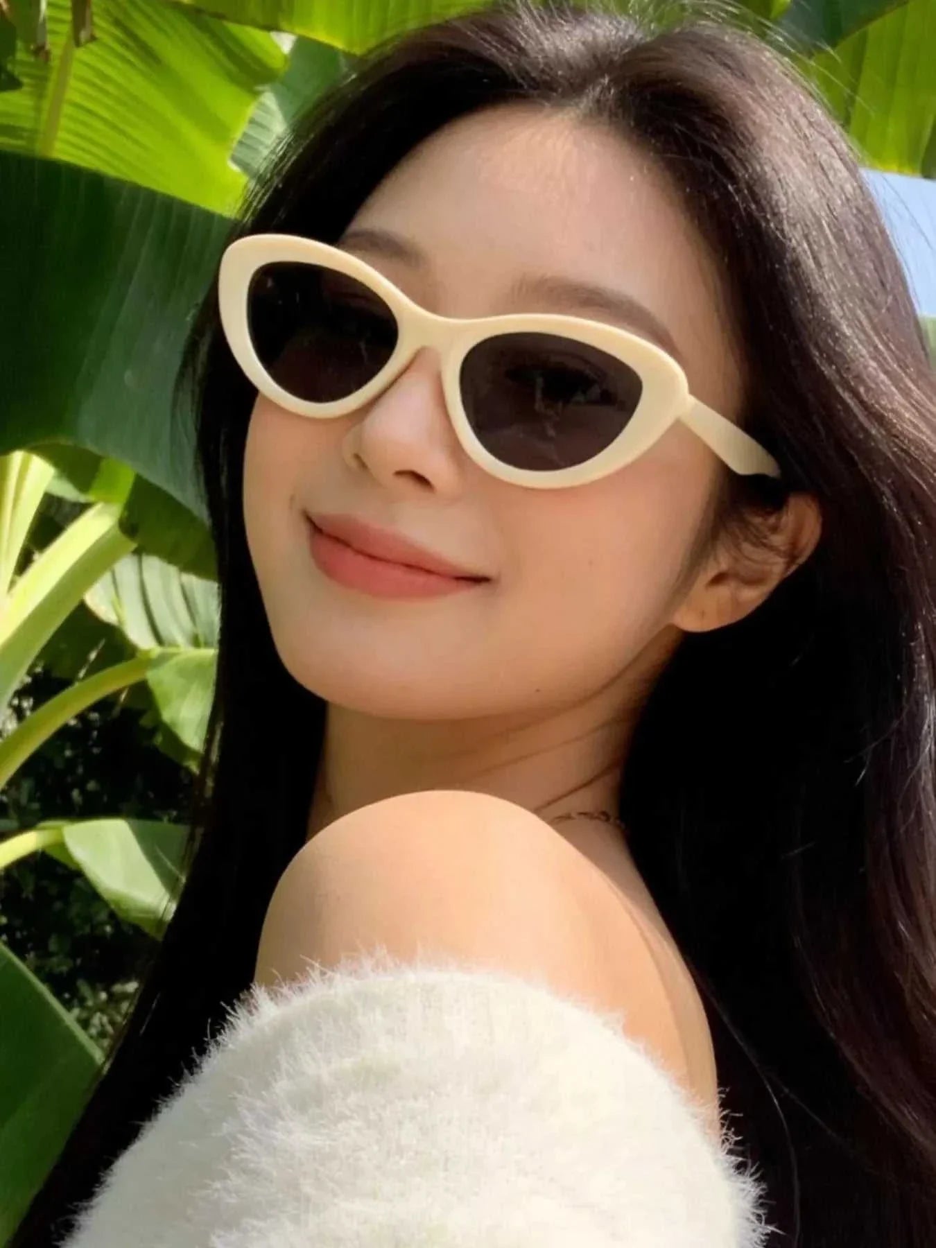 Black cat eye sunglasses with UV400 protection and polycarbonate frame.