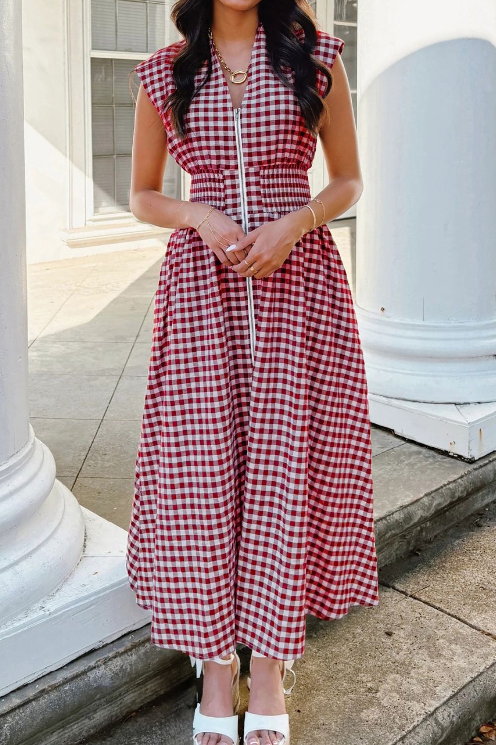 Woman wearing black and white gingham zip-front midi dress with short sleeves and collar
