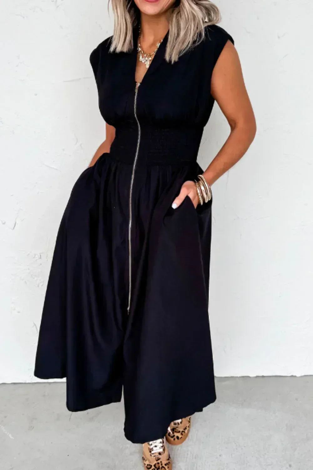 Black sleeveless zip-front maxi dress with pockets, made of 100% polyester, unlined, and machine washable