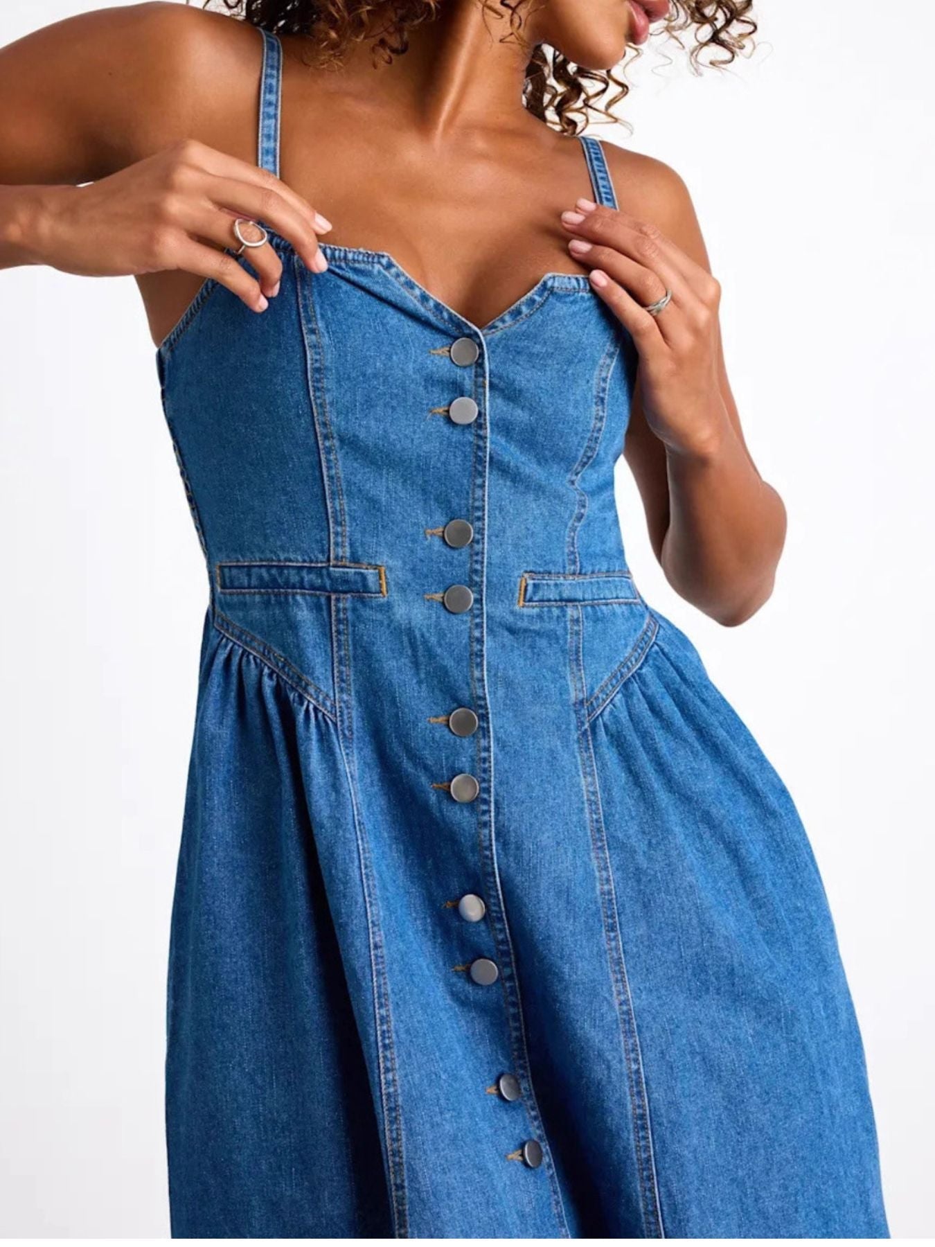 Button-front midi denim dress with smocked waist and pockets, made of 95% rayon and 5% polyester.