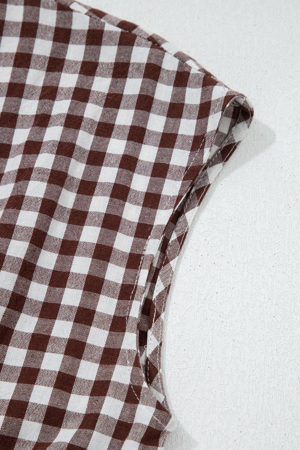 Woman wearing a gingham zip-front midi dress made of cotton blend fabric