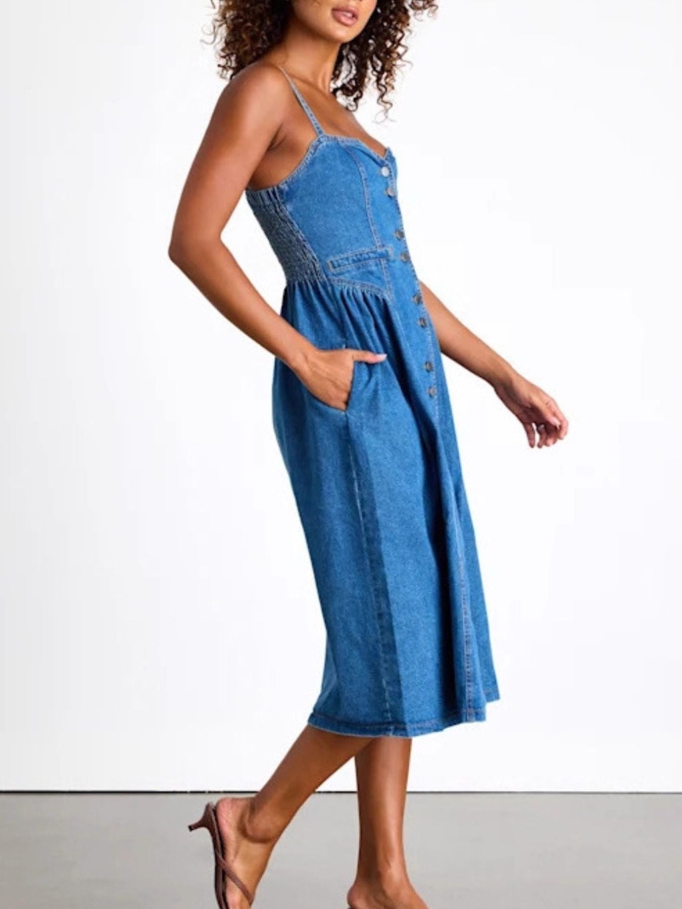 Button-front midi denim dress with smocked waist and pockets, made of rayon and polyester blend.