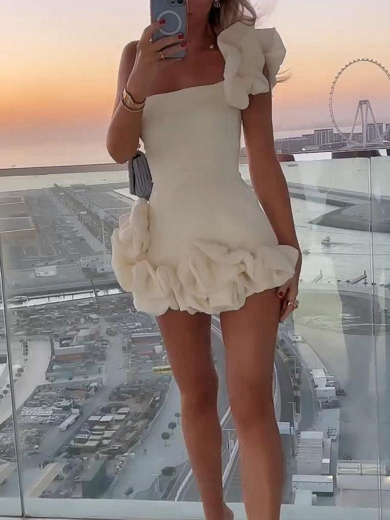 Black one-shoulder ruffle mini dress with slight stretch, made of polyester and spandex