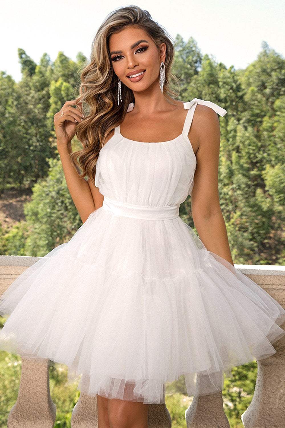 Woman wearing black tie-shoulder mesh dress with lace detail and slight stretch