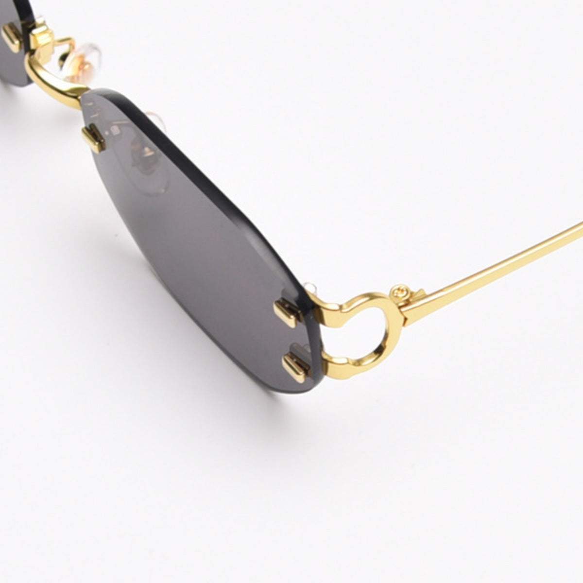 Rimless oval sunglasses with gold metal frame and UV400 protection